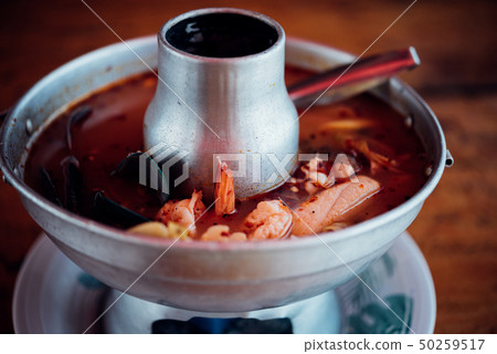 Prawn seafood spicy soup (Tom Yum Goong) at market 50259517