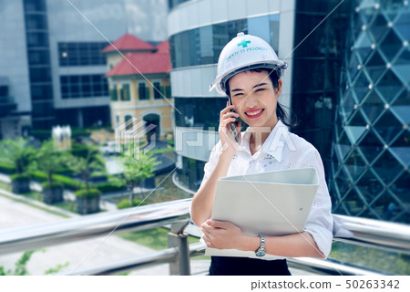 Engineer woman working holding floder and takling Engineer woman working holding floder and takling 50263342