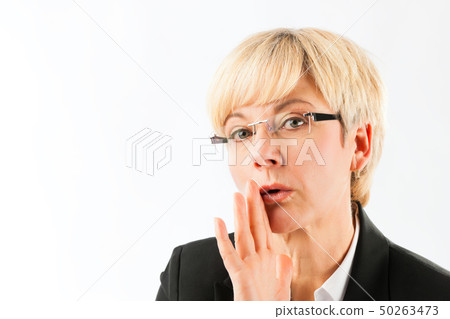 Mature businesswoman saying secret Mature businesswoman saying secret 50263473