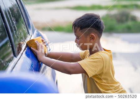 Asian kid boy washing car Asian kid boy washing car 50263520