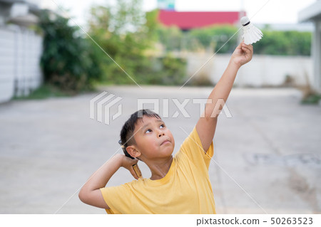 Asian kid boy playing badminton at home Asian kid boy playing badminton at home 50263523