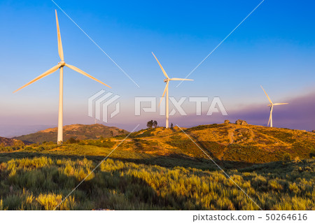 Windmill power generator and famous stone house - 50264616