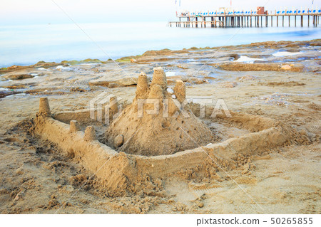 Sand castle on the morning sandy beach. Sand castle on the morning sandy beach. 50265855