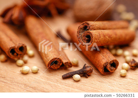 Cinnamon sticks and Dry coriander seeds on wood Cinnamon sticks and Dry coriander seeds on wood 50266331