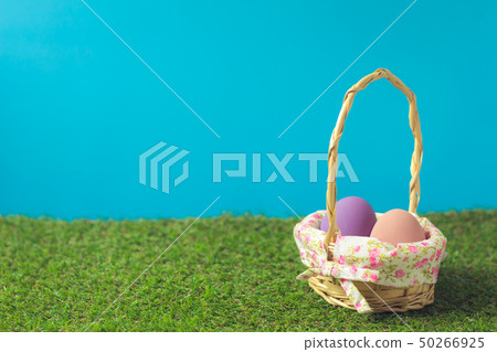 Easter eggs in a basket weave wood on the green Easter eggs in a basket weave wood on the green 50266925