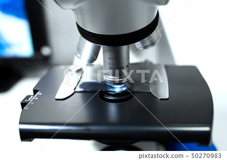 Close up microscope lens on gray background Close up microscope lens on gray background 50270983