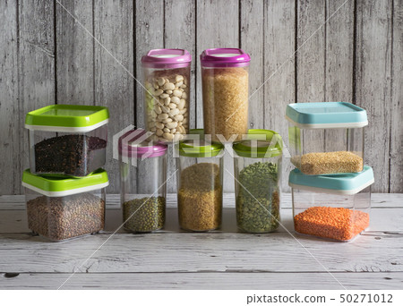 Cereals in plastic containers on a wooden table. Cereals in plastic containers on a wooden table. 50271012
