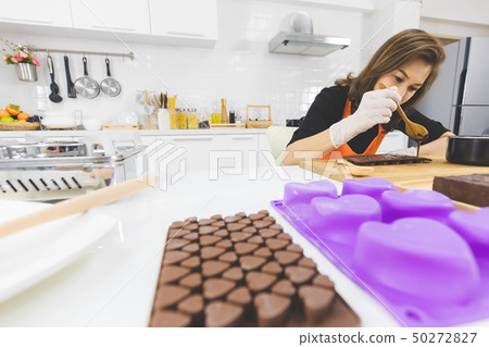 Woman making chocolate Woman making chocolate 50272827