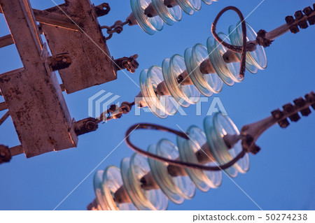 Close up of high voltage insulators at power-tower 50274238