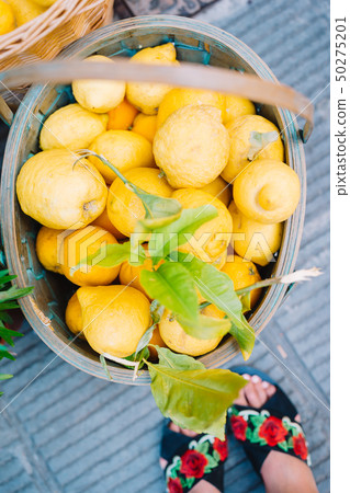 Wicker basket full of lemons on the italian street od Corniglia Wicker basket full of lemons on the italian street od Corniglia 50275201