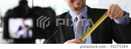 Smile businessman with measure tape records 50275364