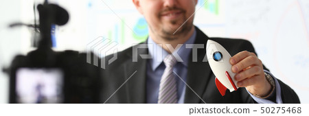 Businessman hold rocket in hand closeup 50275468