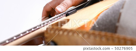 Male arms playing classic shape electric guitar 50276905