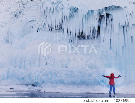 The girl on the background of the ice wall The girl on the background of the ice wall 50276993