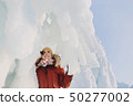 Girl and big icicles 50277002