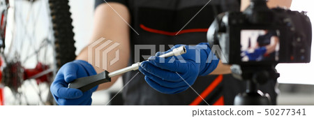 Male blogger hand service man bicycle workshop Male blogger hand service man bicycle workshop 50277341