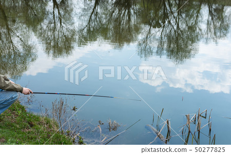 Fisherman catches fish 50277825