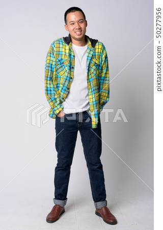 Full body shot of happy young Asian hipster man smiling 50277956