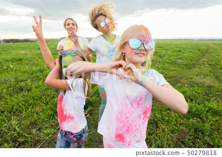 Family, festival of holi and holidays concept - portrait of mothers and daughters covered in paint Family, festival of holi and holidays concept - portrait of mothers and daughters covered in paint 50279818