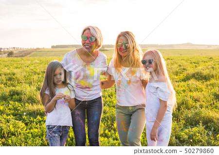Festival of holi, friendship, happiness and holidays concept - little girls and women in glasses 50279860