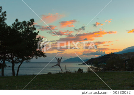 jumping woman during sunset 50280082