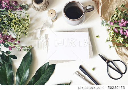 Floral lifestyle, stationery scene. Mums, matthiola flowers, aralia leaf, cup of coffee and vintage 50280453