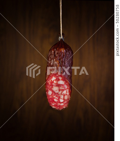 a piece salami sausages on a wooden background a piece salami sausages on a wooden background 50280758