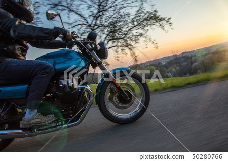 Moto racer riding on forest road. Moto racer riding on forest road. 50280766
