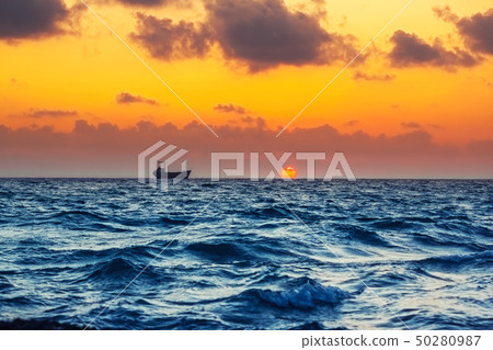 Seascape with cargo ship in sunset time Seascape with cargo ship in sunset time 50280987