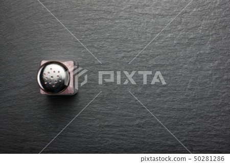 salt shaker with pink Himalayan salt on black salt shaker with pink Himalayan salt on black 50281286