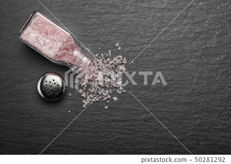 salt sprinkled on black stone background salt sprinkled on black stone background 50281292