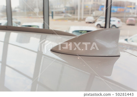 antenna shark fin white color on blurry backgorund. Using wallpaper or background.this car antenna shark fin white color on blurry backgorund. Using wallpaper or background.this car 50281443