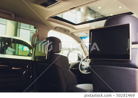 Car inside. Interior of prestige luxury modern car. Three TV displays for passenger with media 50281469