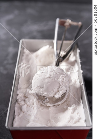 Vanilla ice cream scooped out of container, top 50281604