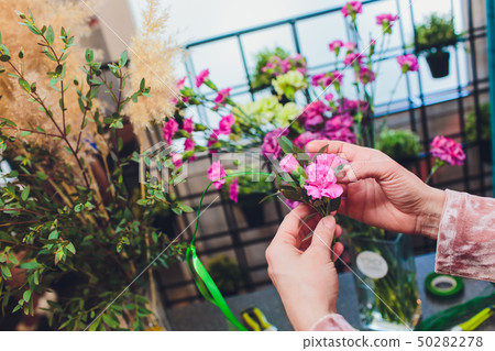 Process of creating a bouquet florist flower shop close-up. Woman hands and implement. Process of creating a bouquet florist flower shop close-up. Woman hands and implement. 50282278