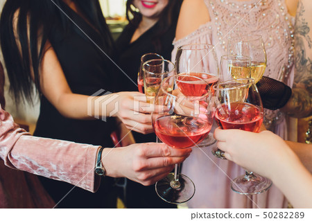 Champagne glasses in hands of people at party. Champagne glasses in hands of people at party. 50282289