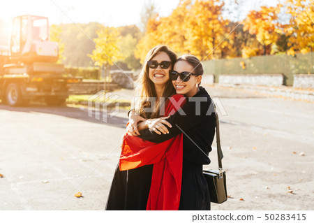 Portrait two beautiful happy girlfriends in the park. 50283415