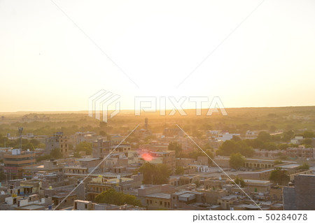 Brick buildings with beautiful sunset over the Jaisalmer desert in Rajasthan, India Brick buildings with beautiful sunset over the Jaisalmer desert in Rajasthan, India 50284078