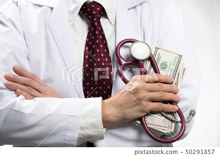 Medical doctor holding money and stethoscope 50291857