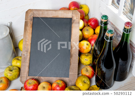 organic fresh apples and bottle of Normandy cider 50293112