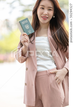 Happy woman preparing for a trip Happy woman preparing for a trip 50294327