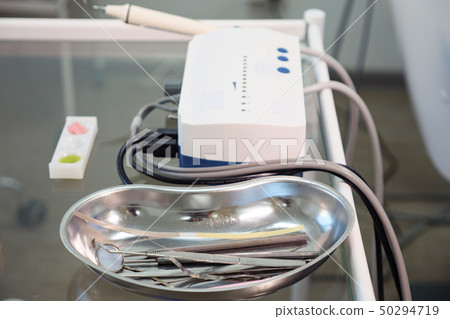 tools from metal tray on glass table. tools from metal tray on glass table. 50294719