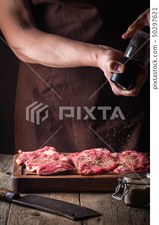 Man cooking meat steaks 50297621