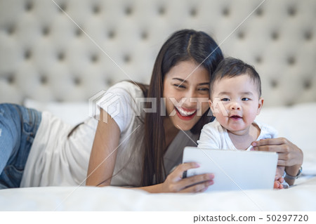 Mother and baby waching a cartoon Mother and baby waching a cartoon 50297720