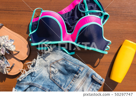 Set of beachwear on wooden background Set of beachwear on wooden background 50297747