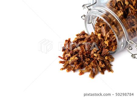 Propolis granules are scattered from a glass jar. Propolis granules are scattered from a glass jar. 50298784