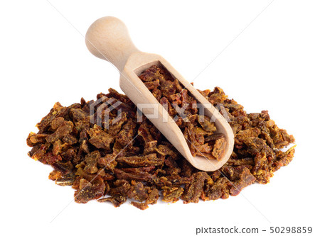 Propolis granules in a wooden shovel are isolated 50298859