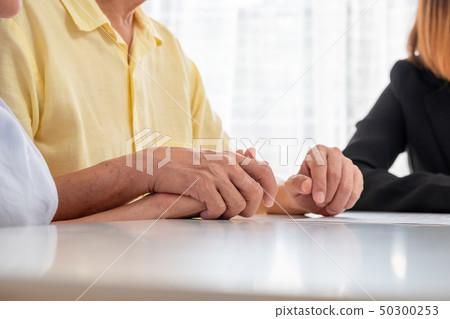 Asian senior couple holding hand with careless and Asian senior couple holding hand with careless and 50300253