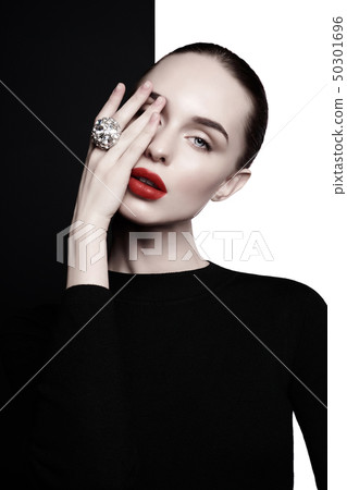 beautiful young woman with big ring pose in studio 50301696