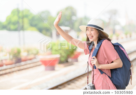 Woman traveler with bag say hi to friend, Woman traveler with bag say hi to friend, 50305980